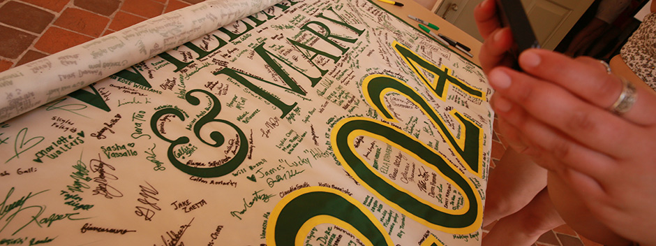 Class of 2024 banner covered in student signatures on a table