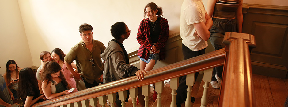 A line of students along the stair case of the Wren Building heading up to ring the Wren Bell