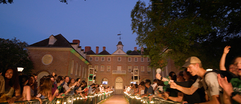 View down a brick walkway that ends at the historic Wren Building, flanked by cheering students as they welcome new students at Opening Convocation