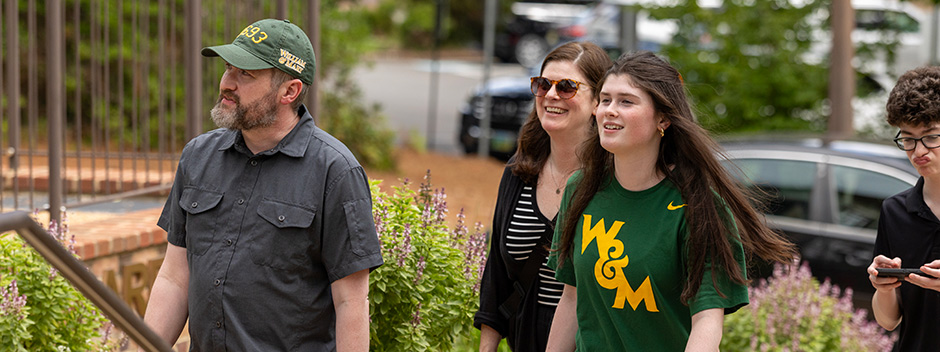 A family walks up the front stairs to the Sadler Center