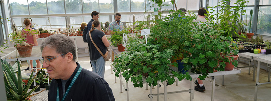 Students and families looking at plants in W&amp;M's rooftop greenhouse