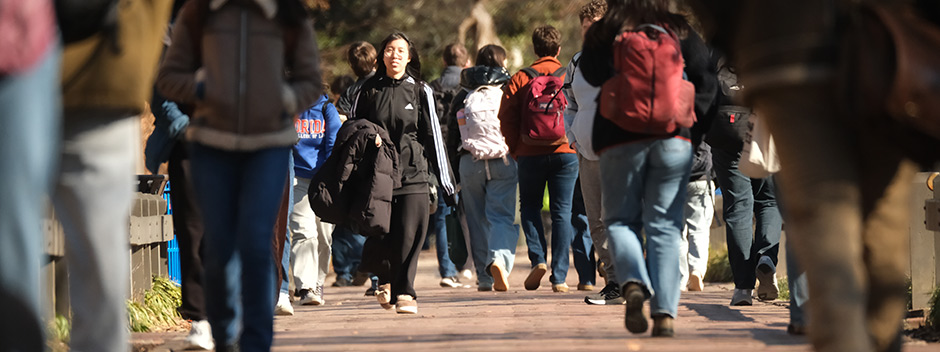 Students walking across campus along brick pathways