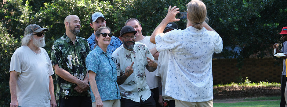 A smiling group of employees gathered in a pose for someone holding a camera