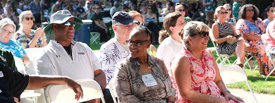 Employees are seated in the Wren Yard with honored guests seated in the forefront